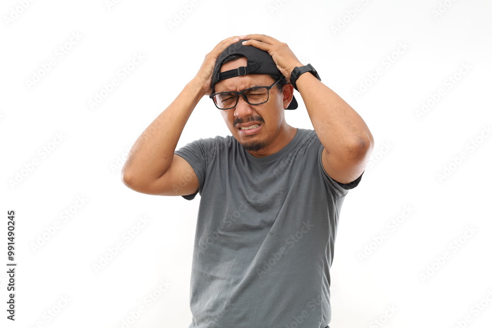 Portrait of exhausted asian man holding hands on head isolated on white background. Portrait of exhausted asian man holding hands on head isolated on white background.