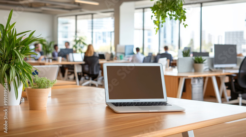 Wallpaper Mural A modern office space featuring laptop on wooden desk, surrounded by greenery and vibrant work environment. scene conveys productivity and collaboration among professionals Torontodigital.ca