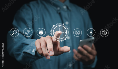 Time management concept. Work planning increases efficiency and reduced work time. businessman holding clock and money icon on interface virtual for business time management..