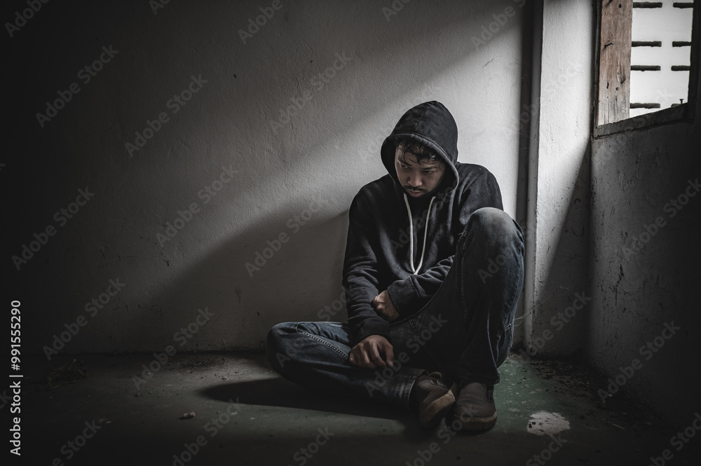 Asian man addict drug in the deserted place,A junkie feels alone in this world,Sad young man sitting in the corner of the room,People are stressed and have depression Asian man addict drug in the deserted place,A junkie feels alone in this world,Sad young man sitting in the corner of the room,People are stressed and have depression