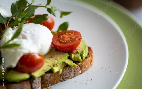 Avocado toast poached egg. Sliced avocado, poached egg, and cherry tomatoes on toasted bread. Perfect for a healthy and delicious brunch.