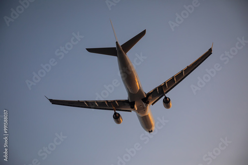 Beautiful airplane takes off at sunset. Sunny evening. Large passenger plane. photo