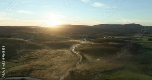 Misty hills in Yorkshire Dales at sunrise photo