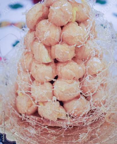 A beautifully crafted croquembouche, made of cream puffs photo