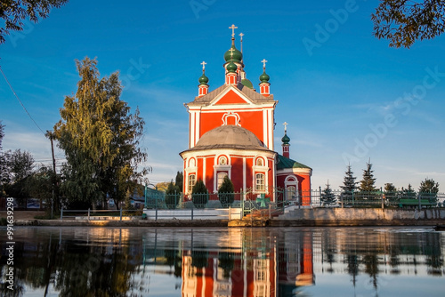 The Golden Ring of Russia, the city of Pereslavl-Zalessky. The Church of the Forty Martyrs of Sebaste is reflected at dawn in Pleshcheyev Lake. photo