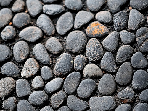 Worn-down pavement with small pebbles and dirt, showing signs of neglect, pebble-strewn pavement, forgotten path photo