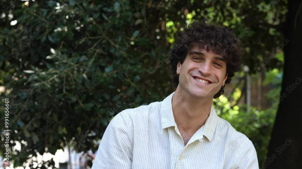 A young man bursts into laughter, looking cheerfully at the camera, radiating happiness and positivity in a moment full of joy A young man bursts into laughter, looking cheerfully at the camera, radiating happiness and positivity in a moment full of joy