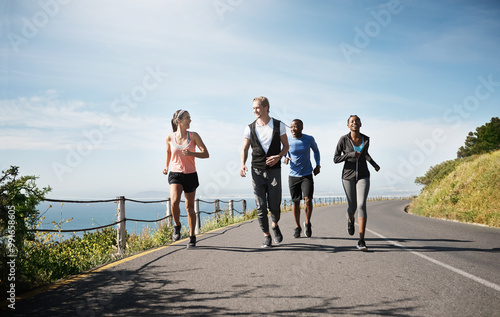 People, couple of friends and running in road for fitness with smile to exercise and workout. Diversity, outdoor and happy with jogging in sportswear for health, wellbeing and self care with routine