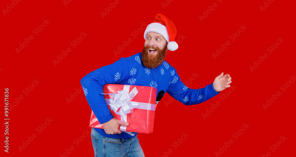 New Year and Christmas. Xmas holiday present. Santa man hurrying for New Year sale. Santa man hold holiday shopping gift isolated on red. Xmas present and gift. Winter shopping sale. Magical moments New Year and Christmas. Xmas holiday present. Santa man hurrying for New Year sale. Santa man hold holiday shopping gift isolated on red. Xmas present and gift. Winter shopping sale. Magical moments