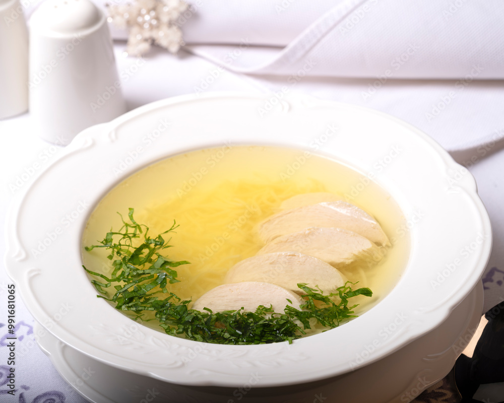 chicken broth with meat in a white plate, top view chicken broth with meat in a white plate, top view