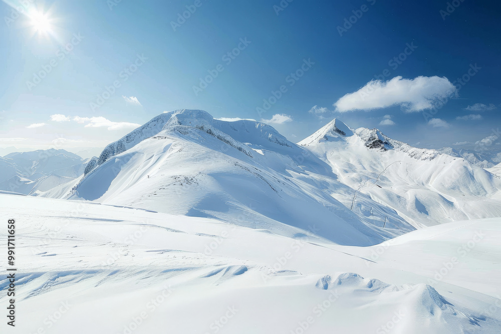 Fototapeta premium A mountain range covered in snow with a clear blue sky