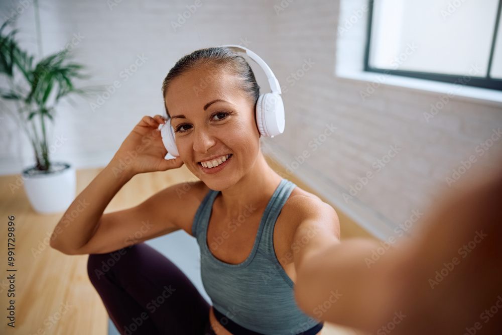 Happy athletic woman with headphones looking at camera. Happy athletic woman with headphones looking at camera.