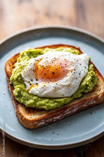 Savoring Avocado Toast with Poached Egg on Light Blue Plate - Fresh and Appetizing Breakfast Delight for Food Blogs and Menus