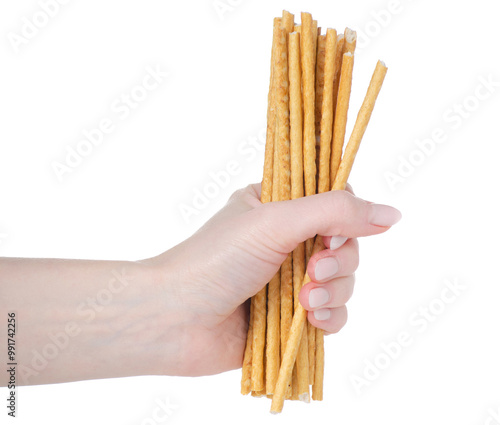 фотографія breadsticks crispy straws in hand isolation