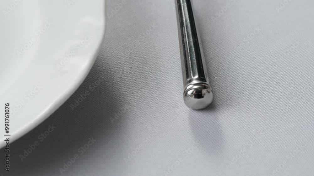 Fancy restaurant, waiter Elegant table setting with white square plate and silverware, arranged for sophisticated dining Fancy restaurant, waiter Elegant table setting with white square plate and silverware, arranged for sophisticated dining