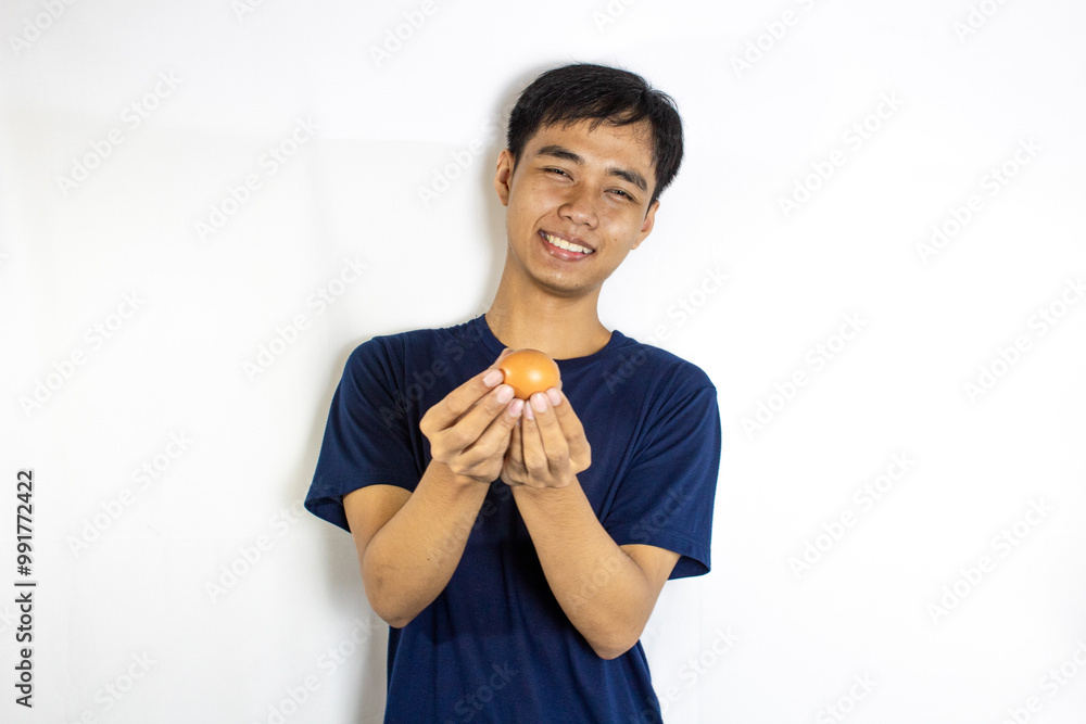 a teenager who was smiling sincerely and holding eggs in both hands carefully a teenager who was smiling sincerely and holding eggs in both hands carefully