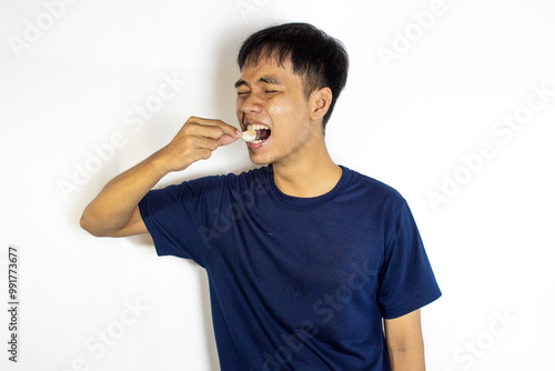 teenager posing casually biting raw garlic