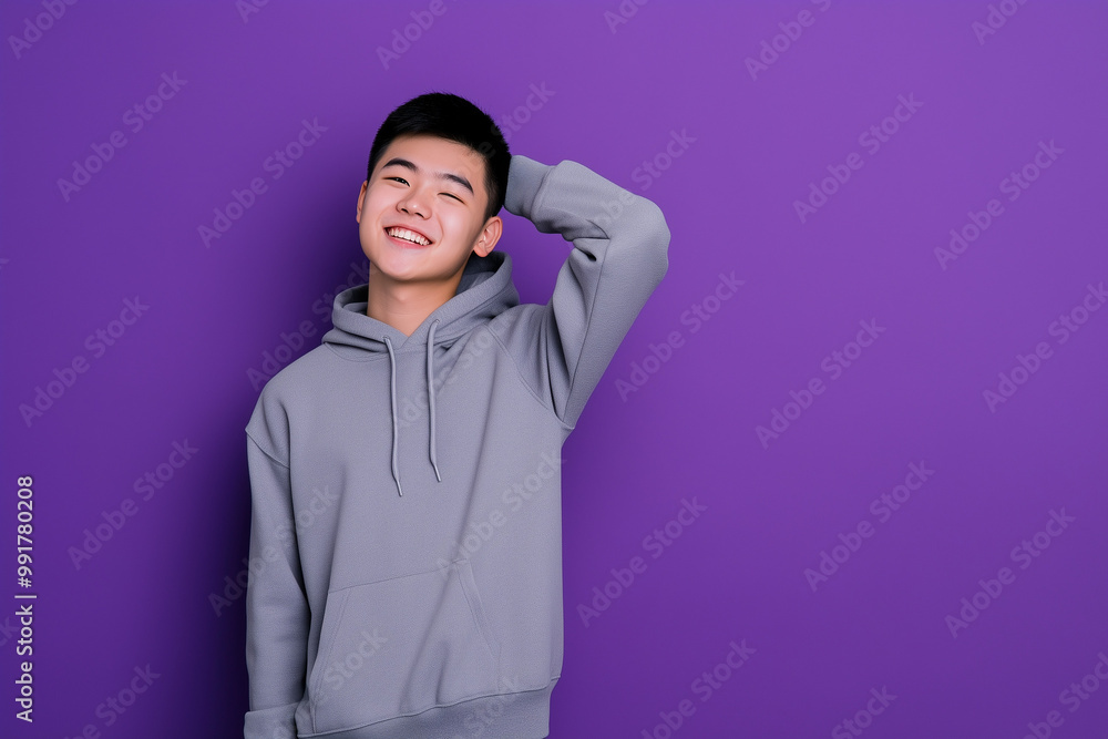 Fototapeta premium Student in hoodie and sweatpants against purple background with confident smile