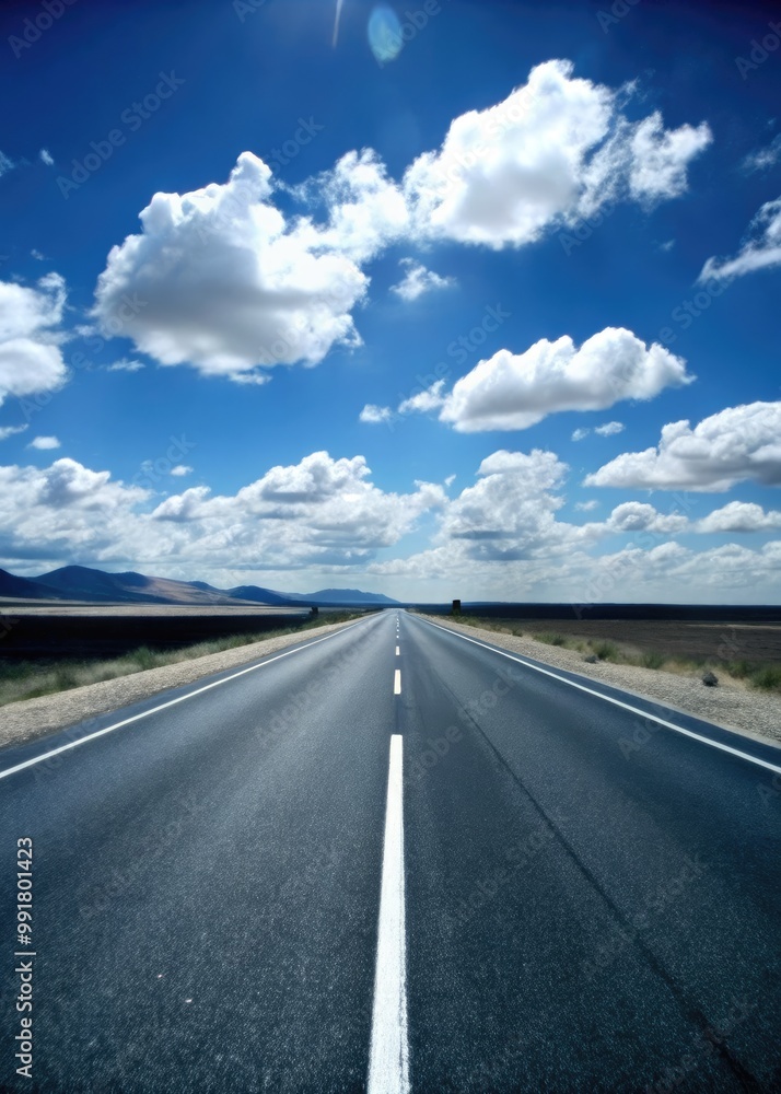 Long open road leading towards a horizon filled with fluffy clouds. Long open road leading towards a horizon filled with fluffy clouds.