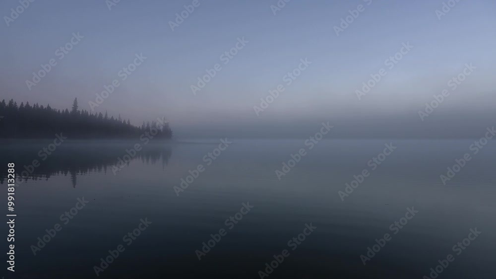Early morning at a large foggy lake with a point of land along the left side. The scene is composed of many muted shades of blue and a little bit of pink.
Early morning at a large foggy lake with a point of land along the left side. The scene is composed of many muted shades of blue and a little bit of pink.
