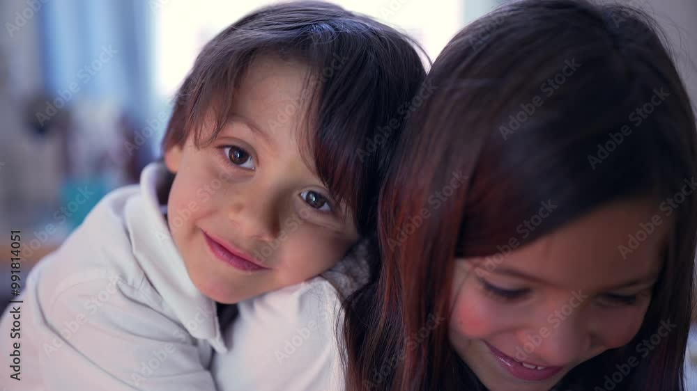 Young boy resting head on older sister’s shoulder, both smiling and enjoying a playful and affectionate moment together in a home environment Young boy resting head on older sister’s shoulder, both smiling and enjoying a playful and affectionate moment together in a home environment