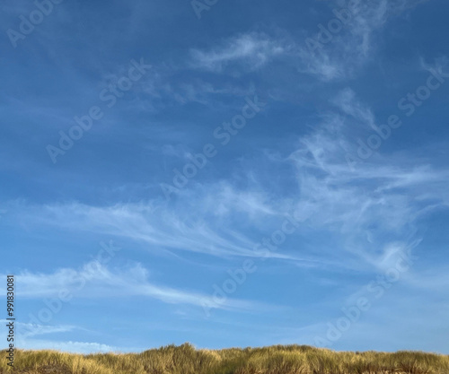 blue sky with whispy clouds