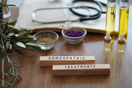 HOMEOPATIC TREATMENTS. table with stethoscope, oils and natural remedies. photo