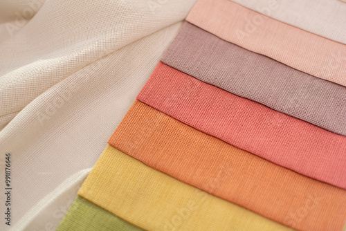 Bright orange and pink fabric with texture for home decor. Fabric samples for curtains and tulles photo