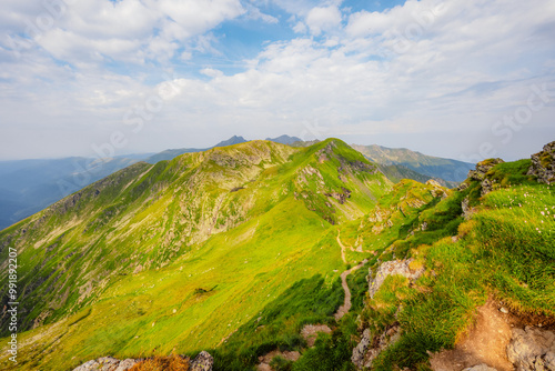 Hiking in Fagaras mountains on Iezerul Caprei peak over Transfagarasan serpentine road carpathian mountains. Mountains landscape photo