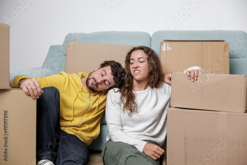 Young couple arguing while moving boxes to move to their new residence. Life is all about beginnings. Paying mortgage for many years. Together everything is easier.