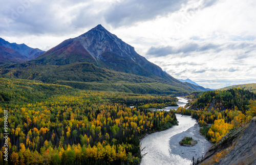 Outside of Matanuska Glacier, Alaska, fall is putting its color on almost everything. River zigzags from mountain top to the foot of tree lines. Travel season is almost closed due to the cold weather.