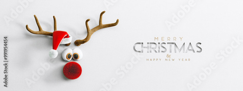 Photos Cute Reindeer with red nose and Santa hat on white paper background
