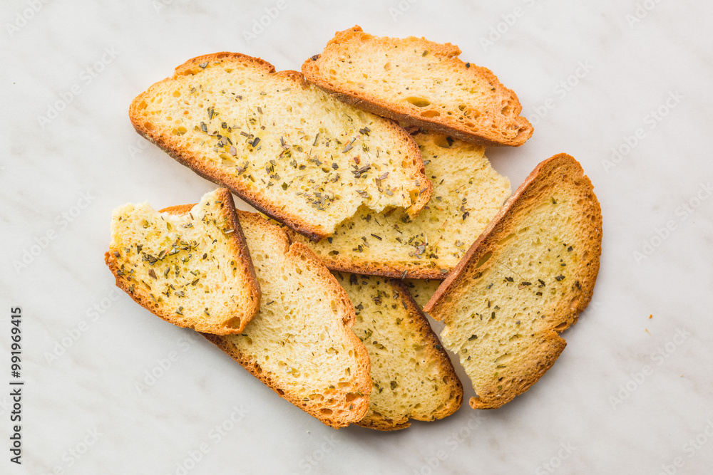 Fototapeta premium Crispy roasted bruschetta bread on kitchen table. Top view.