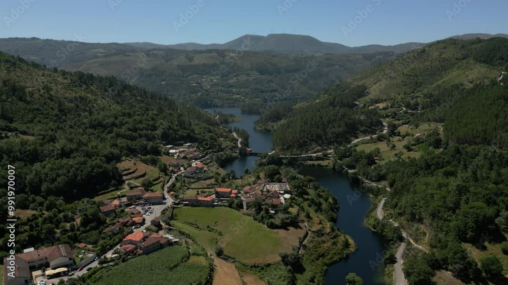 Aerial valley with river, rolling hills, scattered homes in northern Portugal Aerial valley with river, rolling hills, scattered homes in northern Portugal