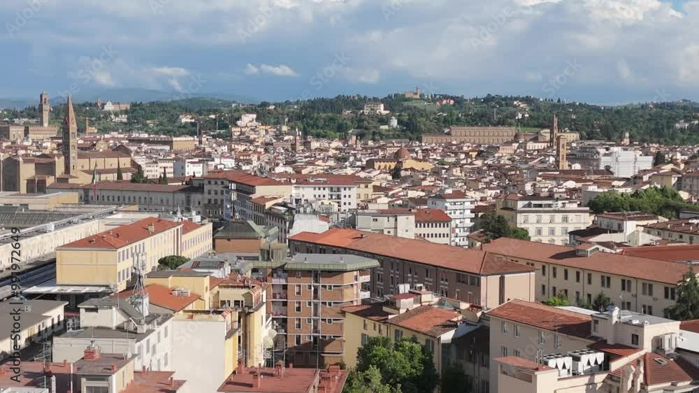Aerial rising over Florence, Italy, horizon of terracotta rooftops and green hills Aerial rising over Florence, Italy, horizon of terracotta rooftops and green hills