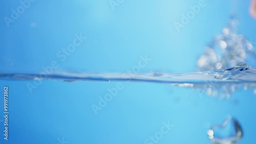 Bursting bubbles of water, create some droplets and waves in a container.