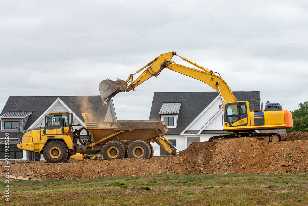 excavator loads earth onto dump truck excavator loads earth onto dump truck