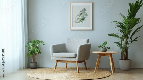A stylish living room with a light, empty wall perfect for displaying artwork. Gray furniture adds a modern touch, while the armchair, table with a green plant, and round rug create a cozy atmosphere.
