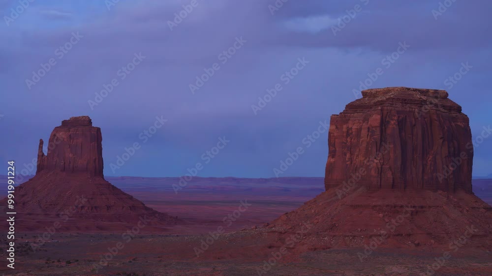 Sunset to sunrise timelapse of West and East Mitten Buttes in Monument Valley desert