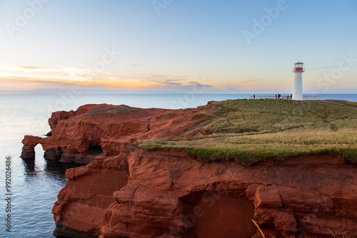 Schilderij op canvas Unrecognizable people at the foot of the Borgot lighthouse on Cap Hérissé at sun