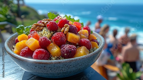 Nance fruit salad fresh greens quinoa walnuts served at a bright outdoor caf with beachgoers and ocean waves softly blurred behind promoting a fresh balanced meal Scientific name Byrsonima crassifolia photo