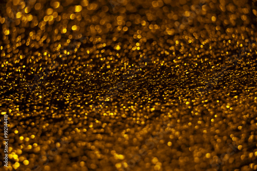 Golden dust sparkle abstract blur with blinking bokeh bright party lights. Abstract Glitter Defocused abstract background. yellow bokeh lights.