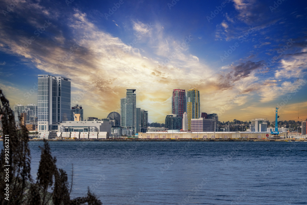 skyscrapers, office buildings, the San Diego Convention Center and cranes along the coast of the San Diego Bay at Coronado Tidelands Park in Coronado California USA skyscrapers, office buildings, the San Diego Convention Center and cranes along the coast of the San Diego Bay at Coronado Tidelands Park in Coronado California USA