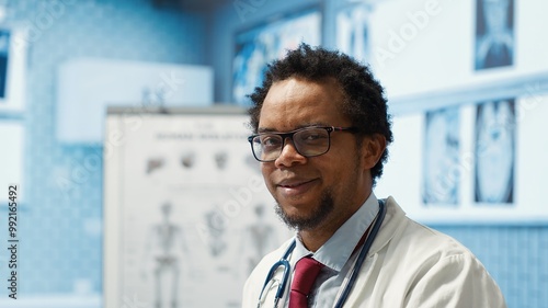 Portrait of specialist with medical disposable gloves examining a patient in cabinet, discussing with woman during a consultation. Professional medic provides healthcare services. Camera A.