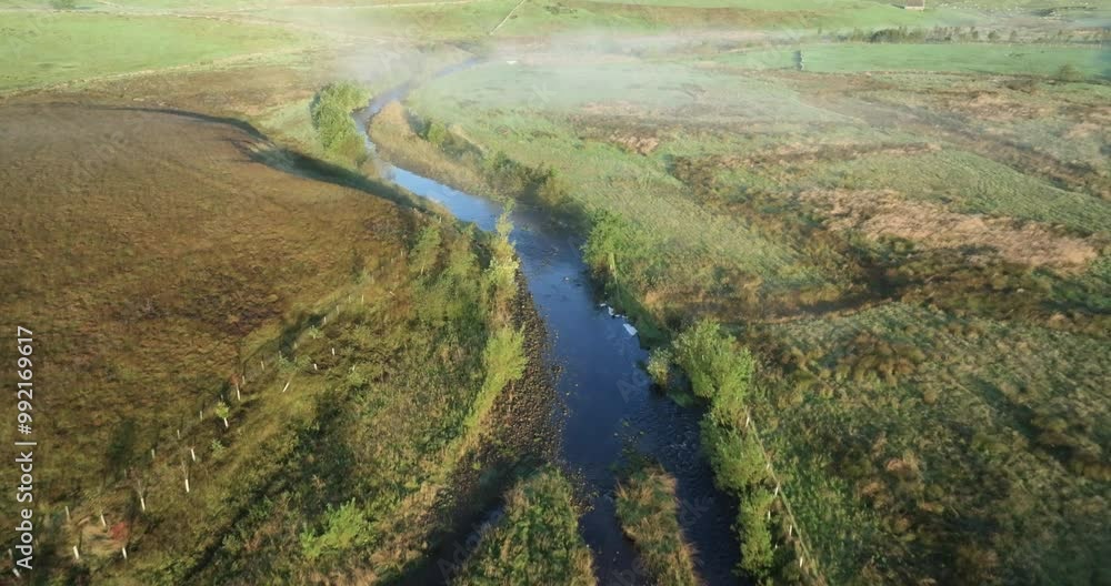 River in a misty valley River in a misty valley