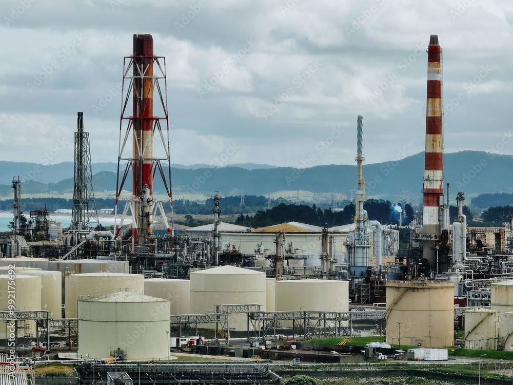 Chimney stacks and storage tanks at the decommisioned Marsden Point Refinery, Whangarei, Northland, New Zealand. Chimney stacks and storage tanks at the decommisioned Marsden Point Refinery, Whangarei, Northland, New Zealand.