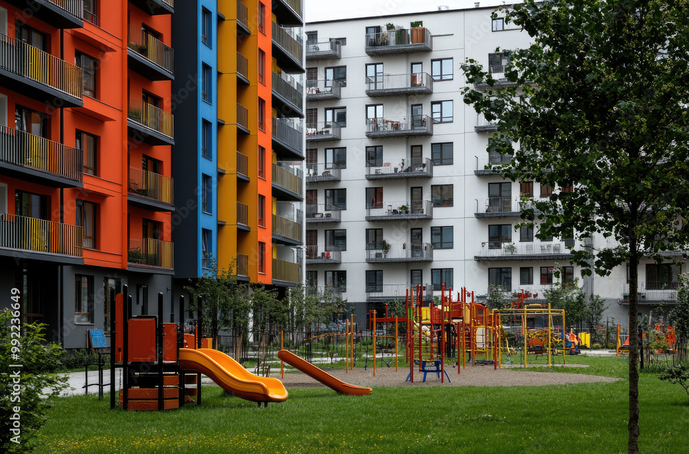 modern apartment buildings with children's playgrounds. In the background, there is a blue sky and green grass. modern apartment buildings with children's playgrounds. In the background, there is a blue sky and green grass.