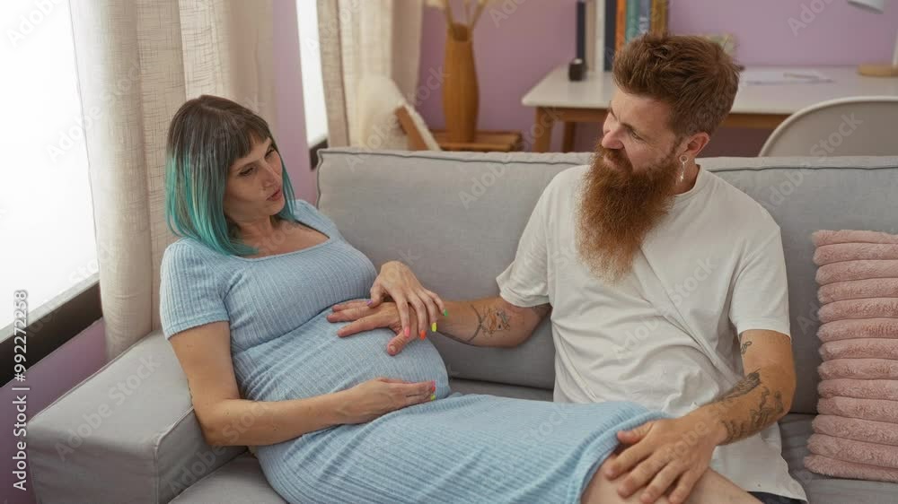 Pregnant woman with man sitting on a couch in a cozy living room, holding hands and smiling in an intimate indoor setting Pregnant woman with man sitting on a couch in a cozy living room, holding hands and smiling in an intimate indoor setting