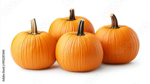 Four orange pumpkins are sitting on a white background