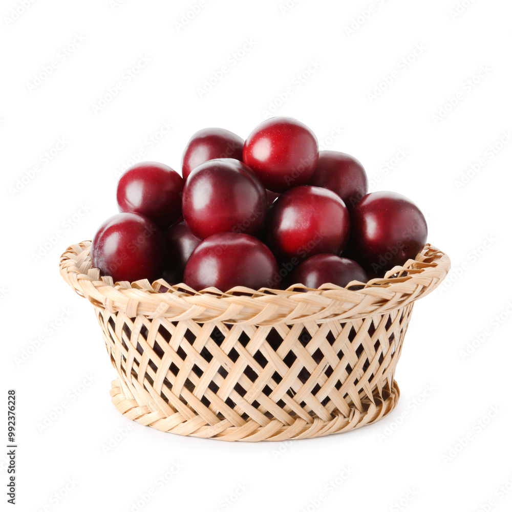 Fresh ripe plums in wicker bowl isolated on white Fresh ripe plums in wicker bowl isolated on white